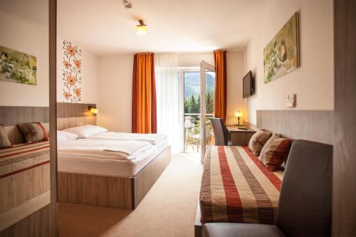 une chambre d'hôtel avec un lit et une fenêtre dans l'établissement Hotel Alta Vista, à Neukirchen am Großvenediger