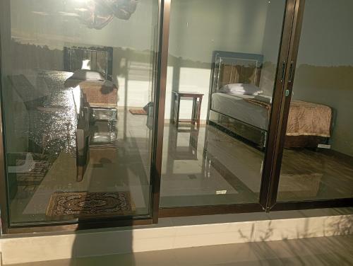 a room with a glass window with a bed in it at Awak Awai in Pulau Rubia