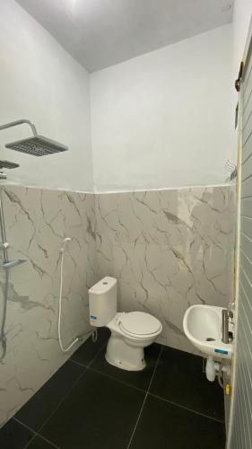 a bathroom with a toilet and a sink at Awak Awai in Pulau Rubia