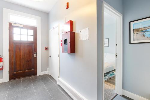 a hallway with a door leading to a bedroom at Quarters on DOT by Thatch in Boston