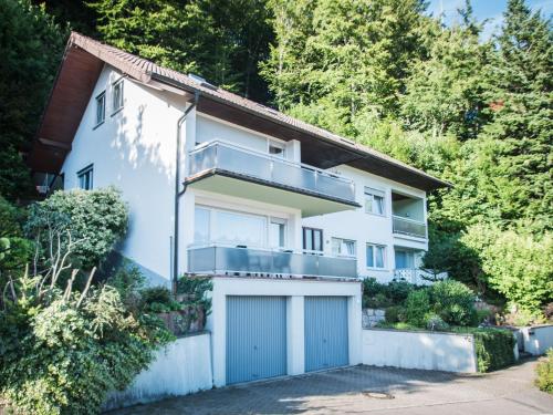 a white house with a garage at Ferienwohnung Matteit in Bad Peterstal