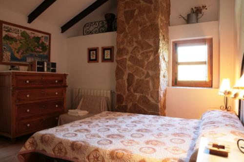 En eller flere senge i et værelse på Alojamiento Rural el Nolo