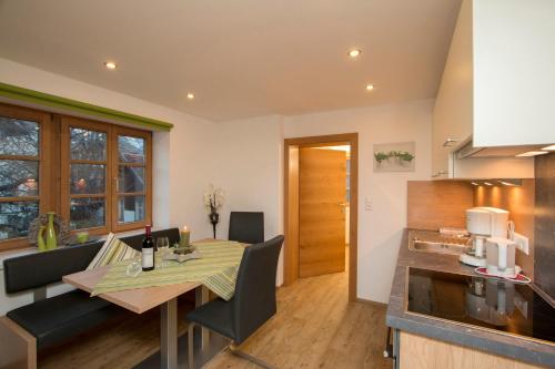 a kitchen and dining room with a table and chairs at Apart Garten Lutz in Prutz