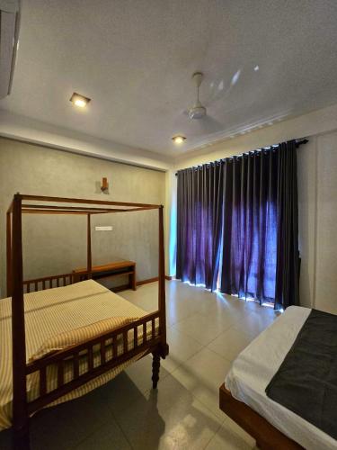 Ένα ή περισσότερα κρεβάτια σε δωμάτιο στο Galle Stay residence