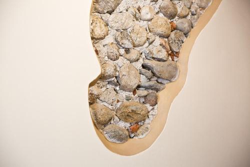 a bunch of rocks in a wooden spoon at Osteria Senza Fretta Rooms for Rent in Cuneo