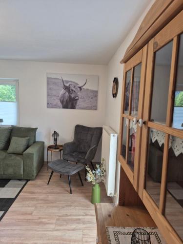 a living room with a couch and a cow on the wall at Ferienhaus Michael in Scharnitz