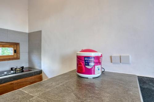 a pink appliance sitting on top of a counter in a kitchen at Kampuak Cottages in Nusa Penida
