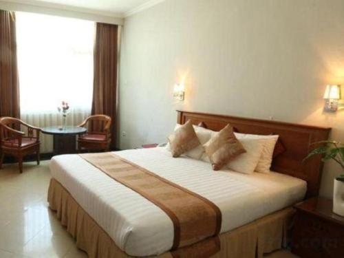 a bedroom with a large bed in a hotel room at Hotel Tarakan Plaza in Tarakan
