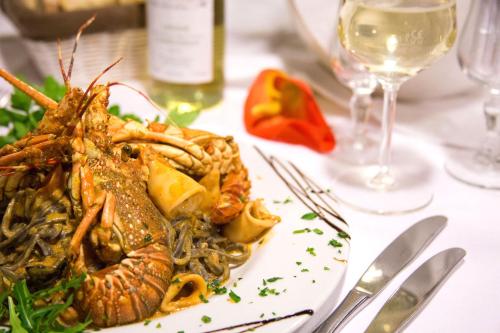a plate of food with a lobster on a table at Hotel Ristorante La Perla in Varallo Pombia