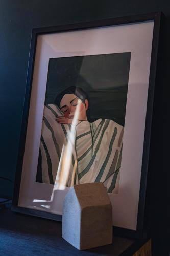a picture of a person with a candle in a picture frame at Nora Poolhouse Oasis, 4-beds house, North Lakes in North Lakes