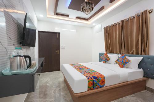 a bedroom with a bed and a television in it at FabHotel Royal Suites I in Bengaluru