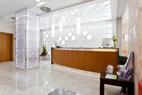 a lobby with a reception desk in a building at Porcel Sabica in Granada