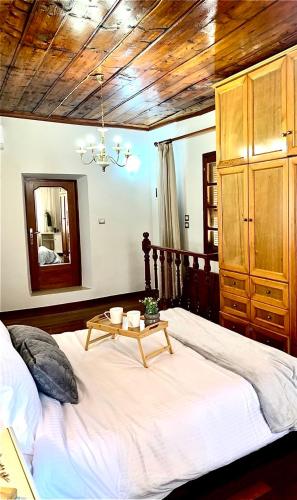 a bedroom with a large bed with a table on it at Eleni's Traditional House in Afantou
