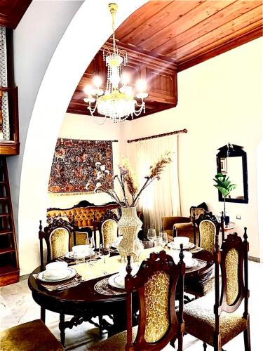 a dining room with a table and a chandelier at Eleni's Traditional House in Afantou