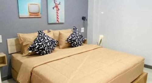 a bedroom with a large bed with pillows on it at The Hub Hotel Surin in Surin