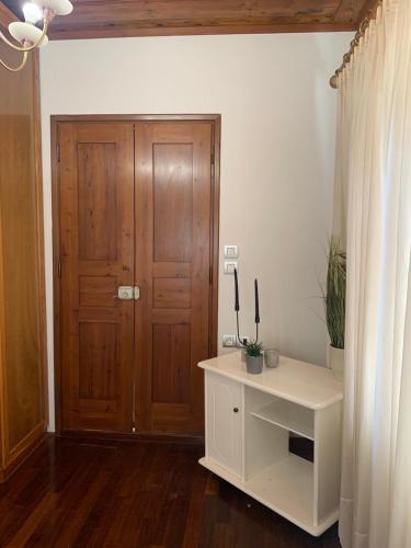 a room with a wooden door and a white cabinet at Eleni's Traditional House in Afantou