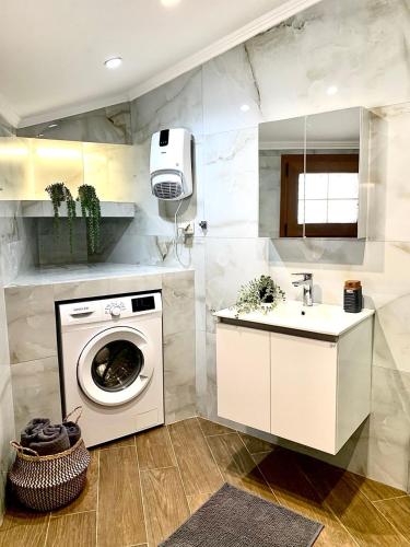 a kitchen with a washing machine and a sink at Eleni's Traditional House in Afantou