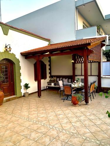 a patio with a pavilion with a table and chairs at Eleni's Traditional House in Afantou