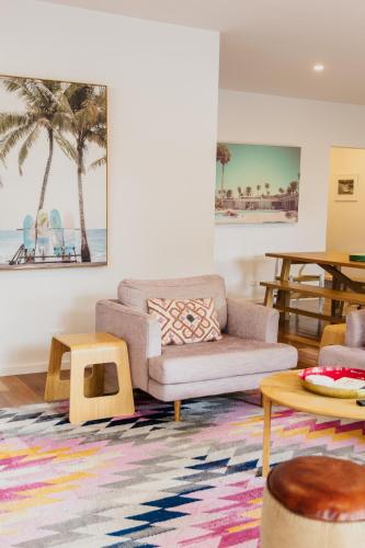a living room with a couch and a table at Bridge Beach House Central Barwon Heads Sleeps 12 Walk everywhere Accessible lower level bedroom and bathroom in Barwon Heads