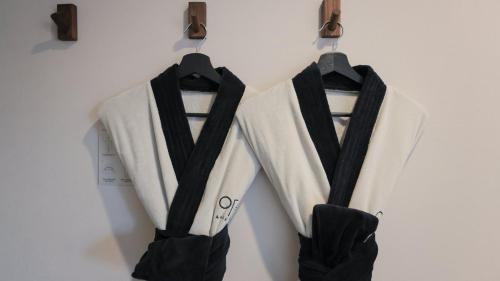 two black and white shirts hanging on a wall at Aank Ryokan Hotel Paju in Paju