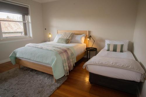 a bedroom with two beds and a window at Webster Hideaway in Wendouree