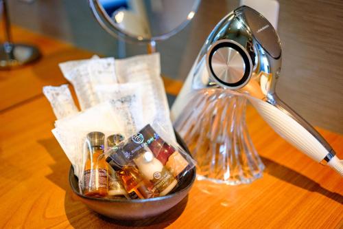 a container of medicines on a table next to a lamp at Sennentei in Yurihama