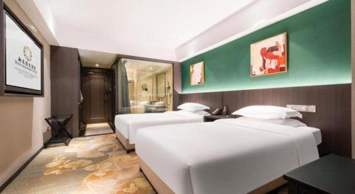 a room with three beds and a bathroom at New Friendship Hotel in Luoyang