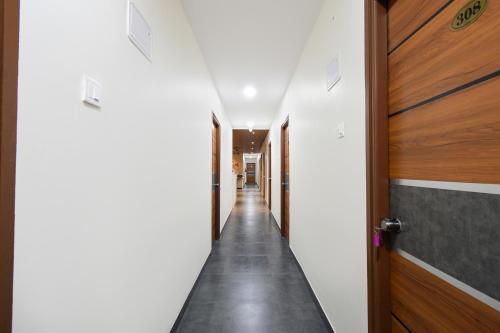 a corridor of hallway with doors and a hallway at FabHotel Yendluri's Abode in Lingampalli
