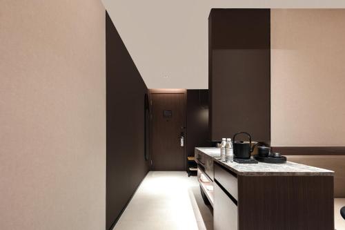 a kitchen with black and white walls and a counter at Atour Hotel Yintai Department Store at Wenzhou South Station in Wenzhou
