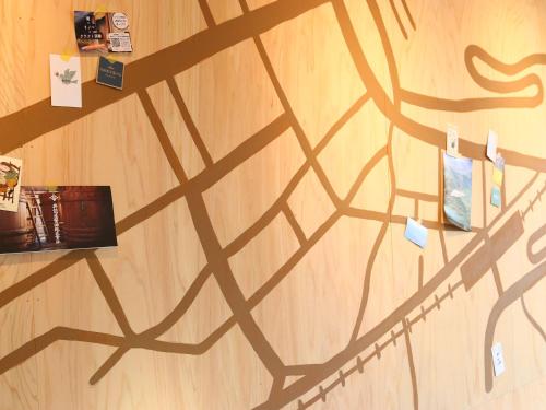 a shadow of a book on a wooden wall at nirasakiyaSTAY in Nirasaki