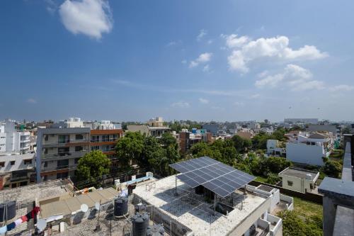 a view of a building with a solar panel on the roof at Leaf 9 Grand, Near Udyog vihar and Yashobhoomi in Gurgaon