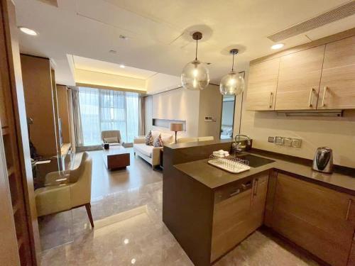 a large kitchen and living room with a couch at Ascott IFC Guangzhou - Free Shuttle Bus For Canton Fair in Guangzhou