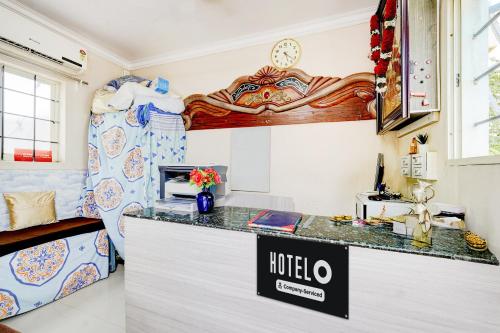 a kitchen with a counter top in a room at Super Hotel O Chittoor Railway Station Formerly Four Oaks in Chittoor