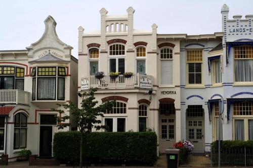 a large white building with balconies on it at Hendrika Apartments in Zandvoort