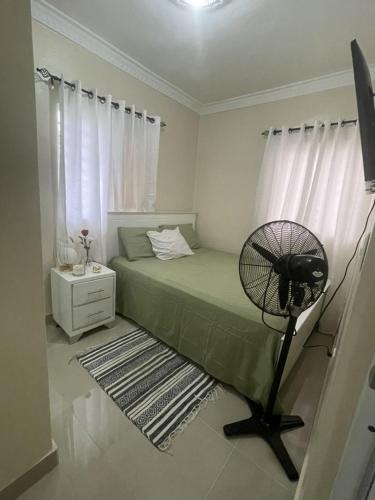 a bedroom with a fan next to a bed at XV Apartamento en san Isidro in Mendoza