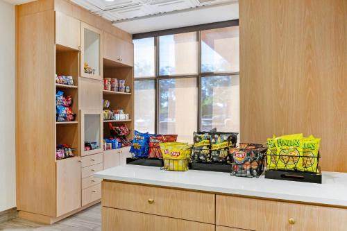 a kitchen with a counter with bags of chips at Comfort Inn & Suites Orlando North in Sanford