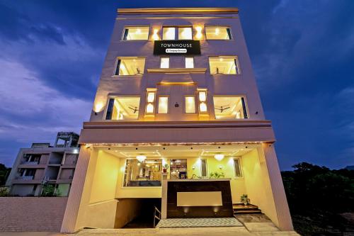 a tall building with a sign on top of it at Super Townhouse Haridwar Vishwakarma Ghat Formerly Haridwar Aagman in Haridwār