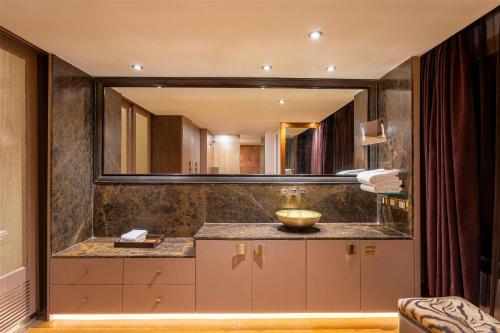 a bathroom with a sink and a large mirror at Radisson Blu Hotel MBD Ludhiana in Ludhiana
