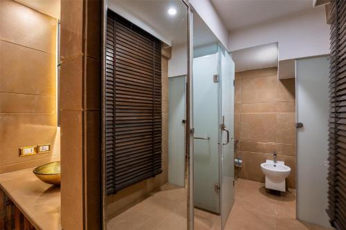 a bathroom with a glass shower and a toilet at Radisson Blu Hotel MBD Ludhiana in Ludhiana