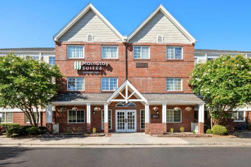 a red brick building with a wellness center at MainStay Suites Raleigh North in Raleigh