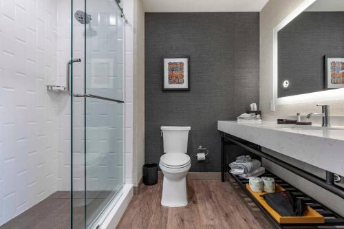 a bathroom with a toilet and a glass shower at Cambria Hotel Columbia Downtown the Vista in Columbia