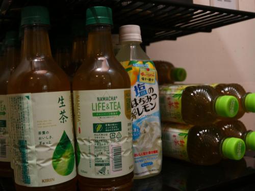 a group of bottles of hot sauce on a shelf at nirasakiyaSTAY in Nirasaki