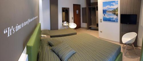 a hospital room with a bed and a tv at Hotel Ideal in Sirmione