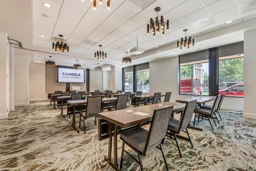 a conference room with tables and chairs and a projection screen at Cambria Hotel Portland - Pearl District in Portland