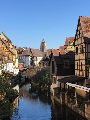 a river in a city with houses and buildings at Colmar guesthouse in old town 6 people in Colmar