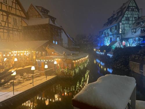 a town lit up with christmas lights in the snow at Colmar guesthouse in old town 6 people in Colmar