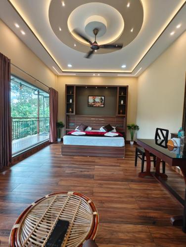 a bedroom with a bed and a ceiling at Linn View Home Stay Munnar in Munnar