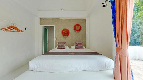 Postel nebo postele na pokoji v ubytování The Buda Resort Muaklek
