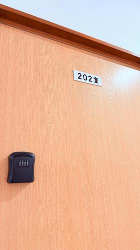 a door with a sign that says on it at 民泊御座岬 Minpaku Gozamisaki in Goza