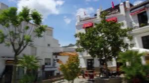 a tall white building with trees in front of it at Hotel Rural Casares in Casares